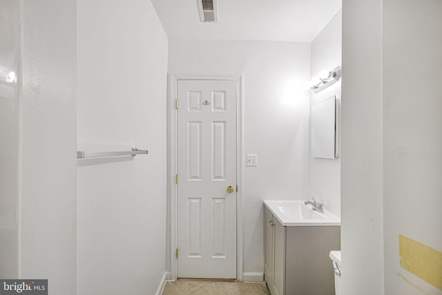 bathroom with tile patterned flooring, toilet, vanity, visible vents, and baseboards