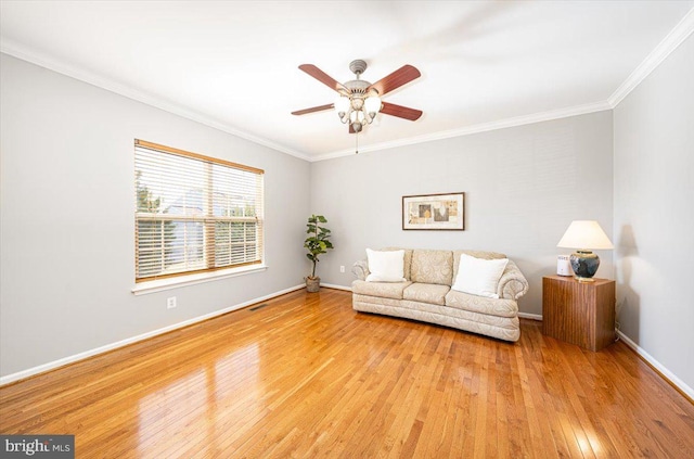 unfurnished living room with baseboards, a ceiling fan, crown molding, and hardwood / wood-style flooring