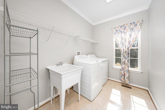 washroom with visible vents, baseboards, laundry area, ornamental molding, and washer and clothes dryer