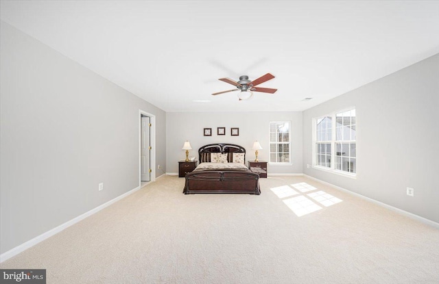 carpeted bedroom featuring baseboards and ceiling fan