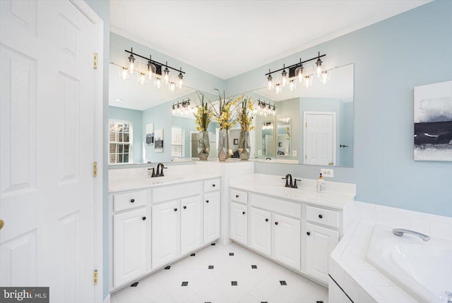 bathroom with two vanities, a bath, and a sink