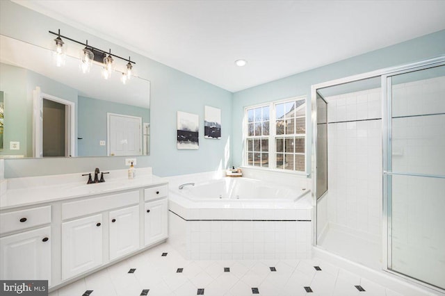 bathroom featuring tile patterned floors, vanity, a garden tub, and a shower stall