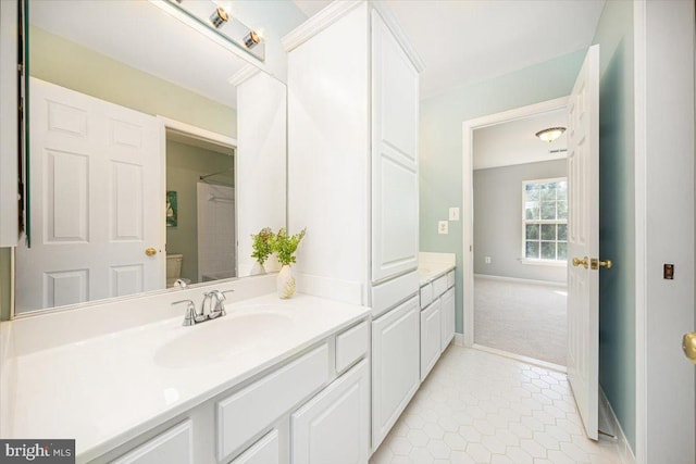 full bathroom with tile patterned flooring, toilet, vanity, and baseboards