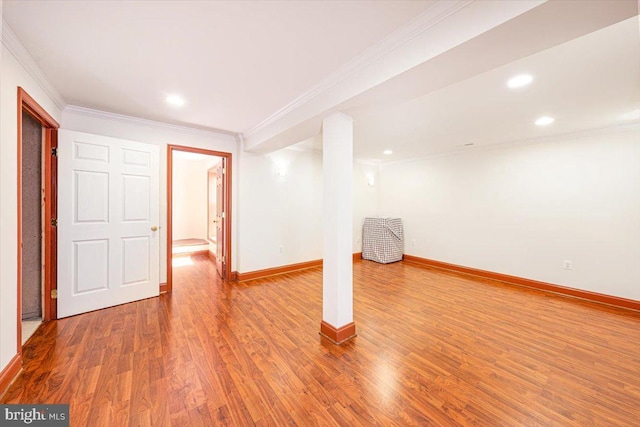 finished basement featuring recessed lighting, wood finished floors, baseboards, and ornamental molding