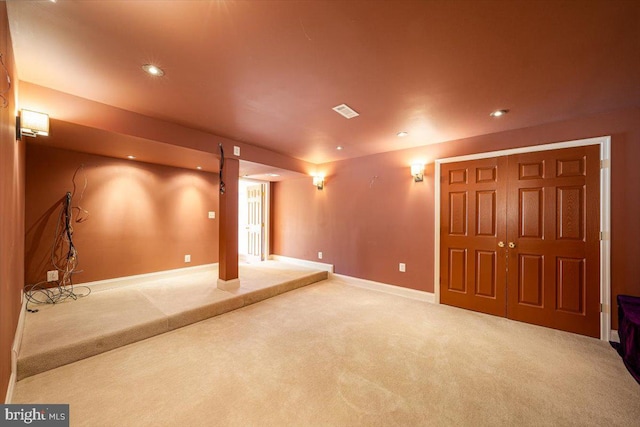 finished basement with carpet flooring, recessed lighting, baseboards, and visible vents