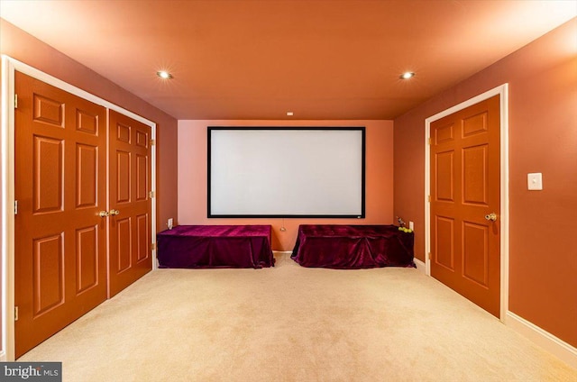 carpeted cinema room with recessed lighting