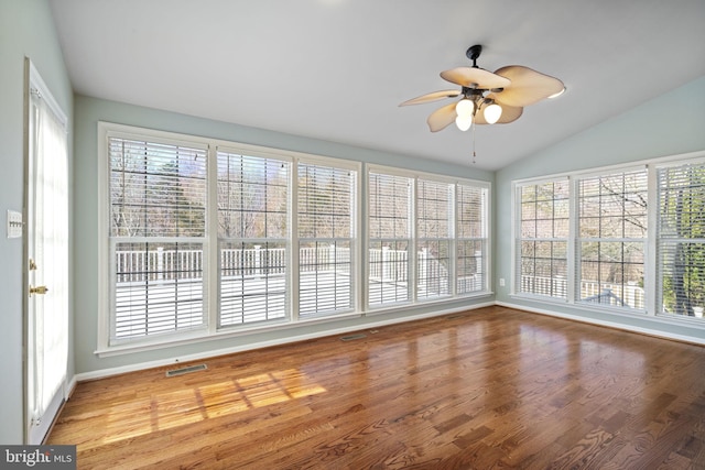 unfurnished sunroom featuring visible vents, a ceiling fan, and vaulted ceiling