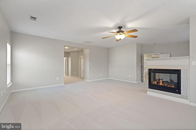 unfurnished living room with baseboards, visible vents, and a multi sided fireplace