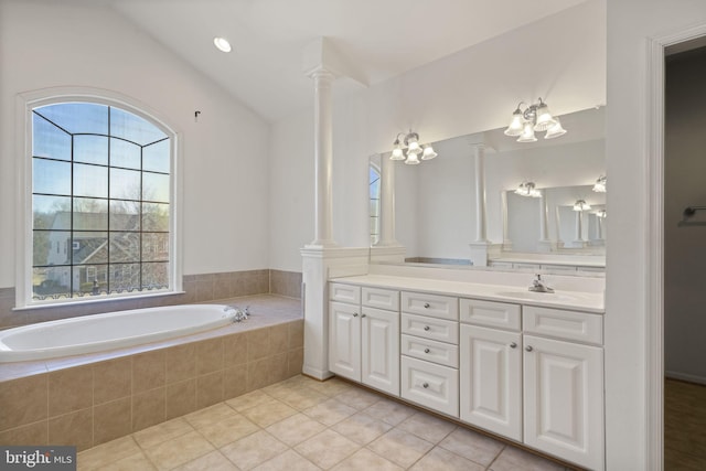 bathroom with tile patterned flooring, a bath, vanity, and decorative columns