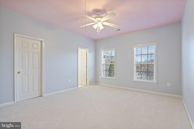 unfurnished bedroom featuring visible vents, a ceiling fan, baseboards, and carpet floors