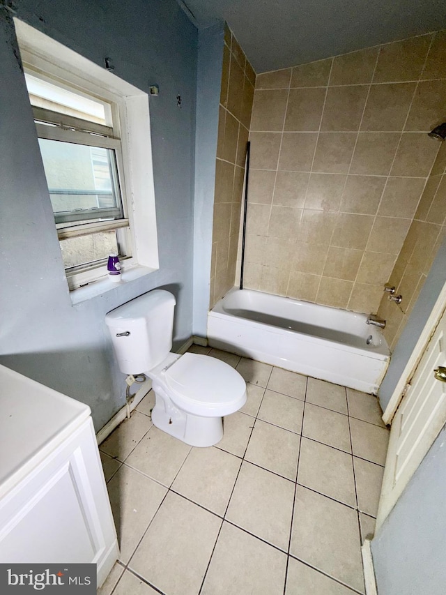 full bath featuring shower / bathtub combination, toilet, and tile patterned floors