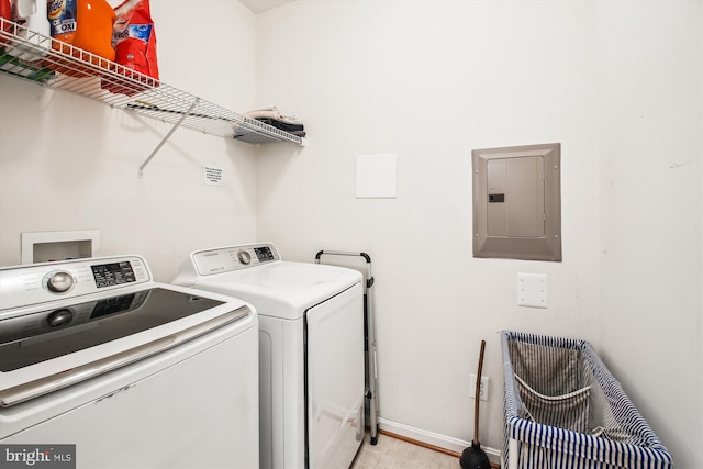 laundry area with laundry area, electric panel, washer and clothes dryer, and baseboards