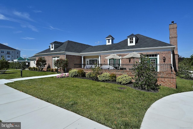 view of front facade featuring a front lawn and brick siding