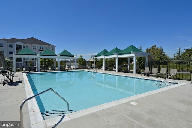 pool featuring a patio area, fence, and a gazebo