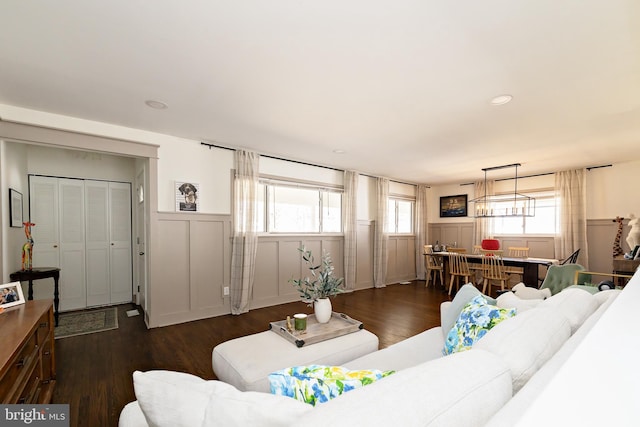 living area with recessed lighting, dark wood-style flooring, a wainscoted wall, and a decorative wall