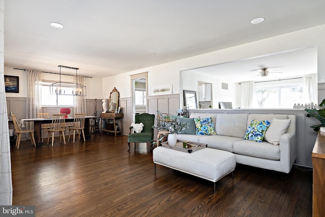 living room featuring plenty of natural light, hardwood / wood-style floors, and wainscoting