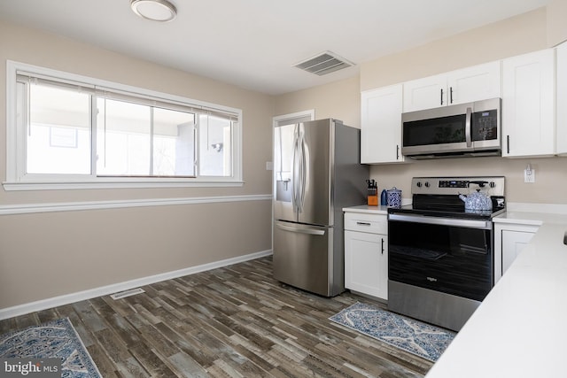 kitchen featuring white cabinetry, visible vents, stainless steel appliances, and light countertops