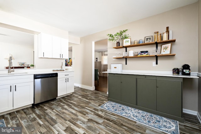 kitchen featuring dark wood finished floors, white cabinets, a sink, and stainless steel dishwasher