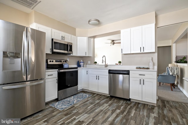 kitchen featuring light countertops, visible vents, appliances with stainless steel finishes, white cabinetry, and a sink