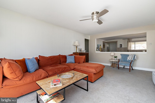 living area with ceiling fan, carpet floors, and baseboards