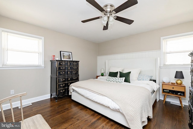 bedroom featuring a ceiling fan, baseboards, visible vents, and dark wood-style flooring