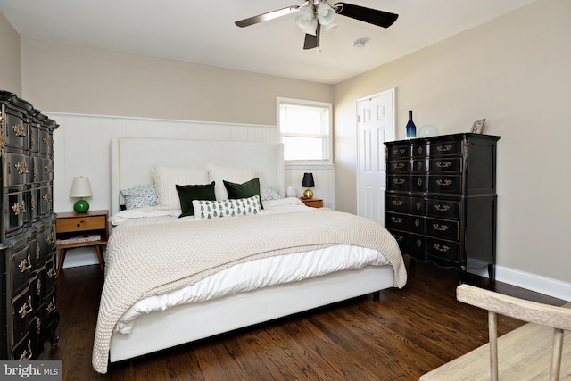 bedroom featuring a wainscoted wall, ceiling fan, and wood finished floors