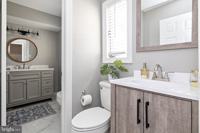 bathroom featuring marble finish floor, vanity, and toilet