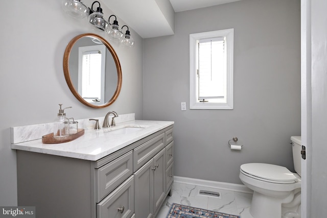 bathroom featuring baseboards, visible vents, toilet, marble finish floor, and vanity