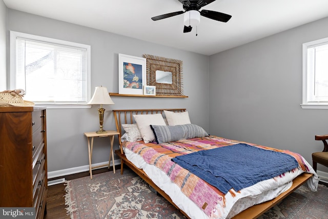 bedroom featuring ceiling fan, baseboards, and wood finished floors