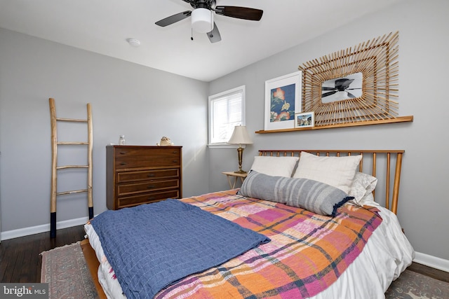 bedroom with ceiling fan, wood-type flooring, and baseboards