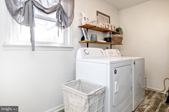 laundry area with laundry area, baseboards, separate washer and dryer, and wood finished floors