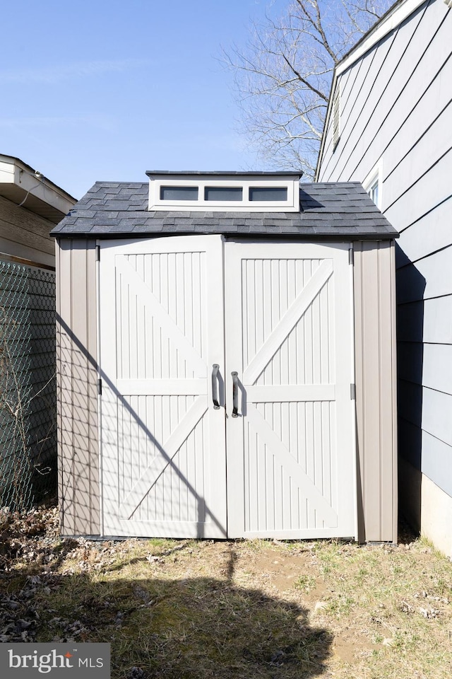 view of shed with fence