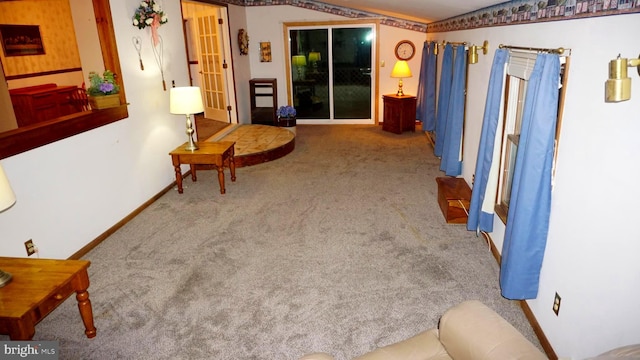 sitting room with baseboards and carpet