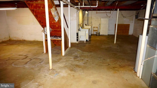 unfinished basement featuring washer and clothes dryer