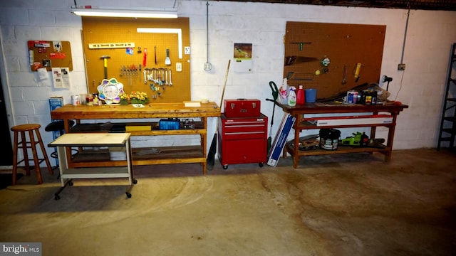 garage featuring a workshop area and concrete block wall