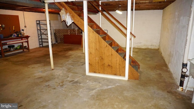 unfinished basement featuring stairs