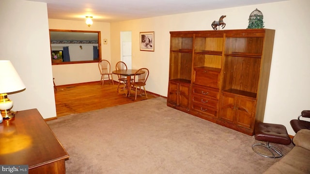 sitting room with baseboards and carpet floors