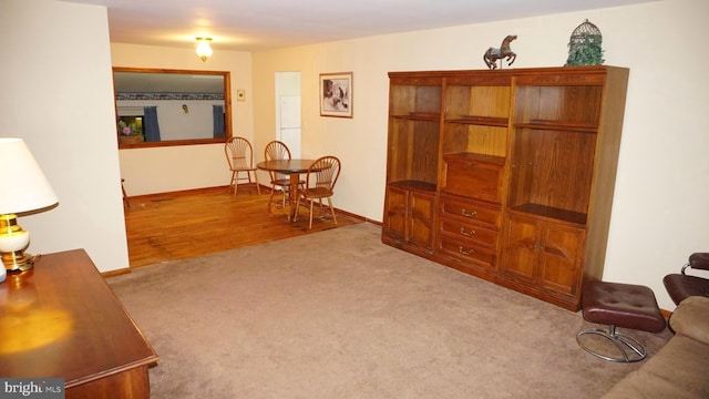 sitting room featuring baseboards and carpet flooring