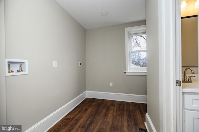 laundry room featuring dark wood-style flooring, hookup for a washing machine, hookup for an electric dryer, laundry area, and baseboards