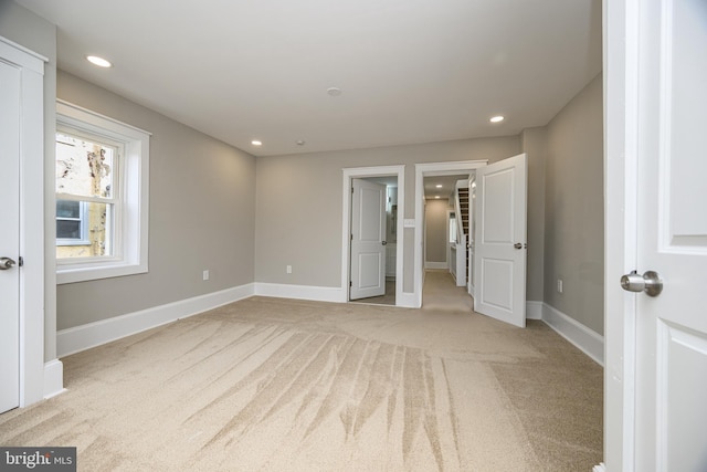 unfurnished bedroom with recessed lighting, carpet flooring, and baseboards