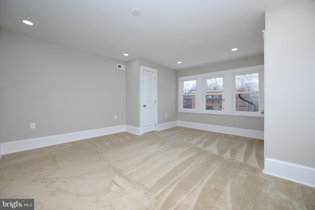 spare room featuring carpet floors, recessed lighting, and baseboards