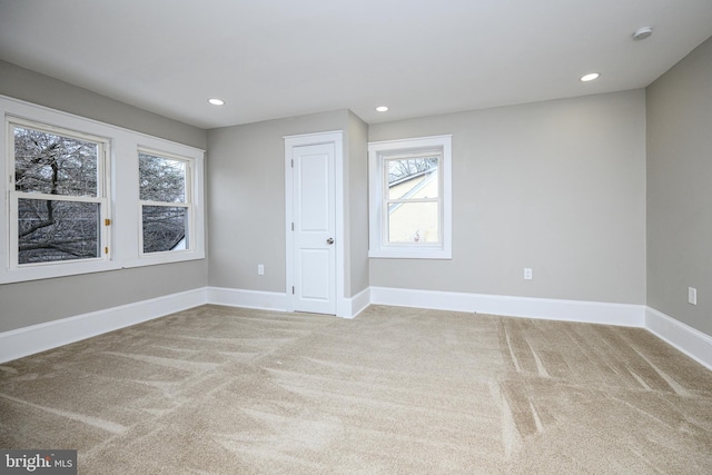 empty room featuring recessed lighting, carpet flooring, and baseboards