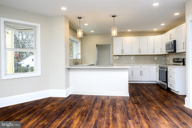 kitchen featuring a healthy amount of sunlight, white cabinetry, stainless steel appliances, and light countertops