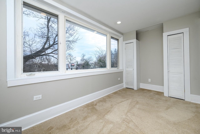 unfurnished bedroom featuring baseboards, carpet flooring, and recessed lighting