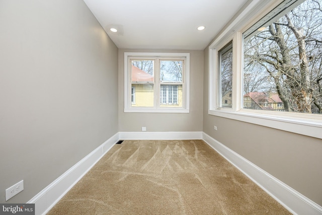 unfurnished room featuring recessed lighting, baseboards, and light colored carpet