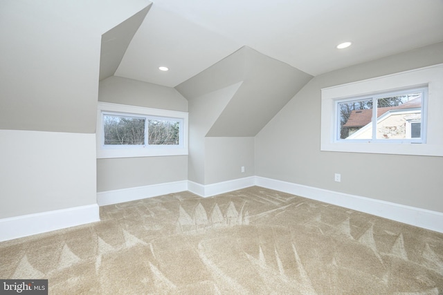 additional living space featuring carpet floors, lofted ceiling, baseboards, and recessed lighting