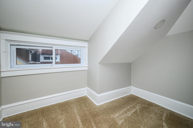 bonus room featuring carpet flooring, vaulted ceiling, and baseboards