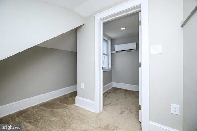 additional living space with a wall unit AC, baseboards, carpet floors, and lofted ceiling