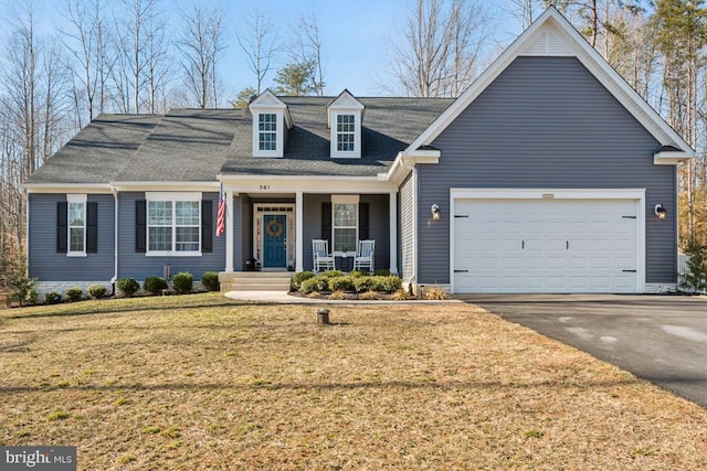 view of front of house featuring an attached garage, a porch, a front lawn, and aphalt driveway