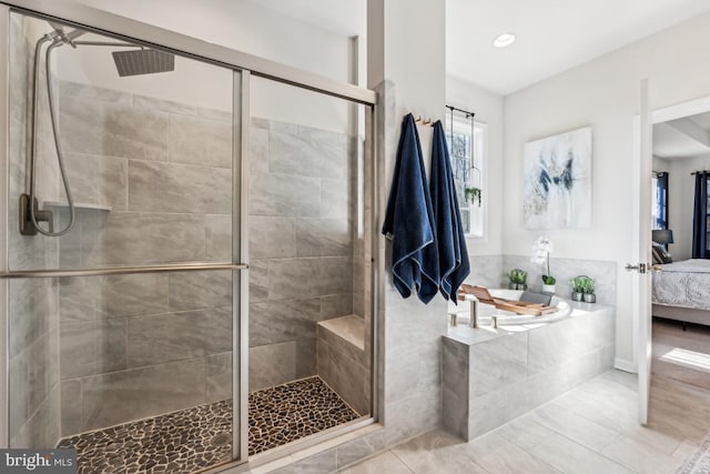 full bath featuring ensuite bathroom, a shower stall, a bath, and tile patterned floors